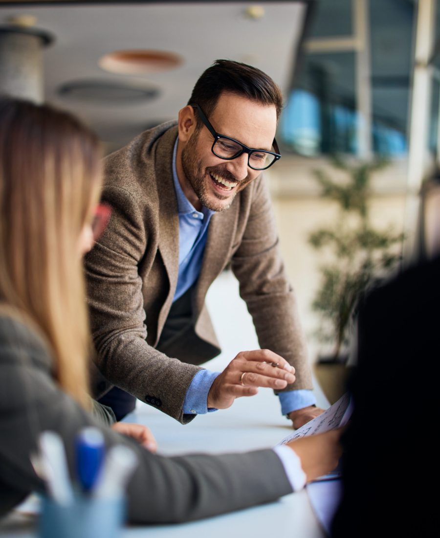 Group of professionals collaborating in an office setting for business planning.